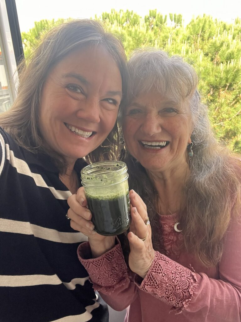 Rosemary Gladstar and Helen Ward holding Rachel Jeans Ultimate Green Drink in Portugal, 2026